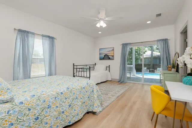 a spacious bedroom with a bed and a large window with outer view