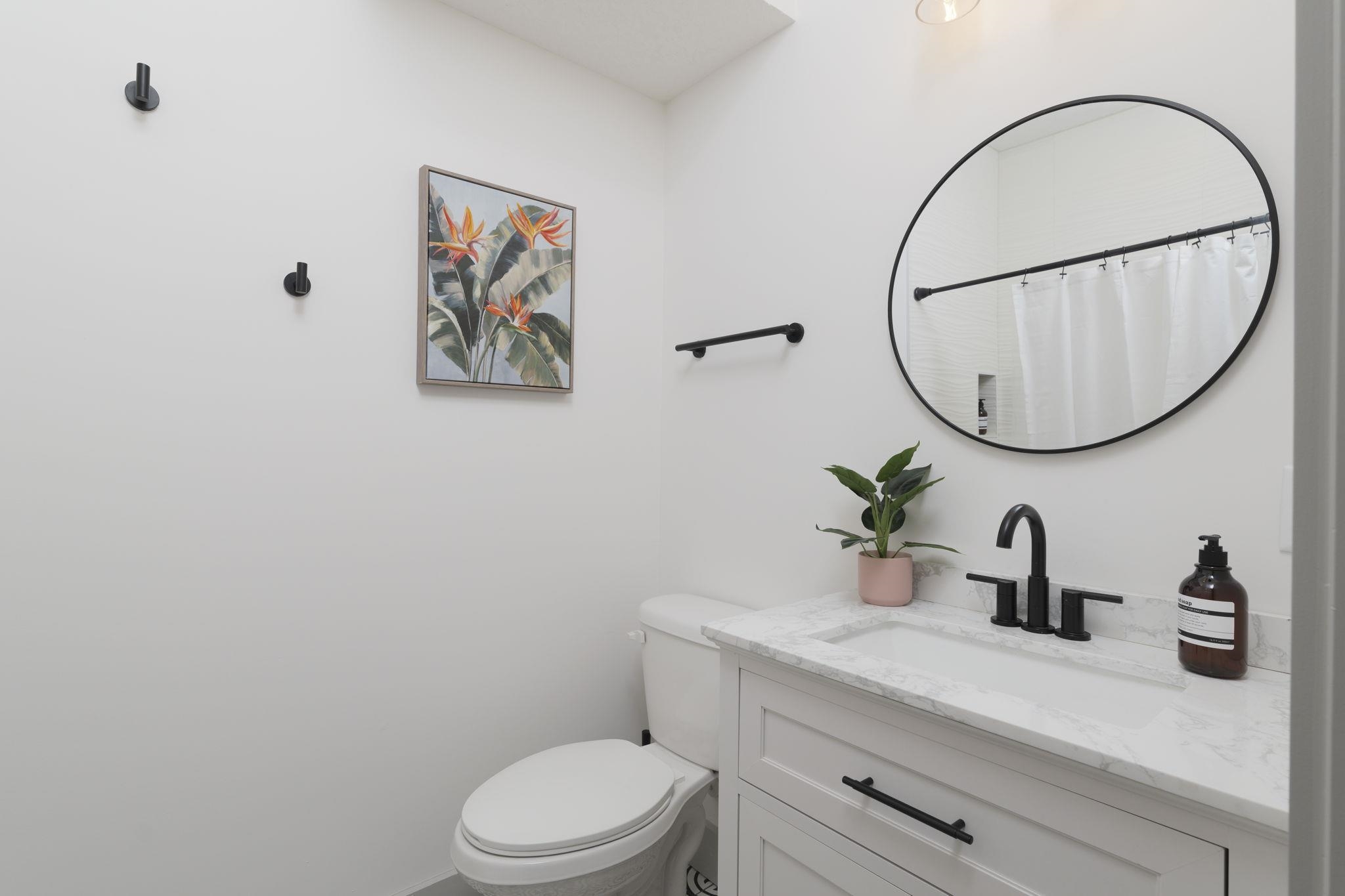 160 Blanco Street St. Augustine, FL 32084 - Photo 7 of 43 a bathroom with a toilet a sink and mirror