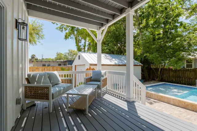 a view of a chair and tables in the balcony