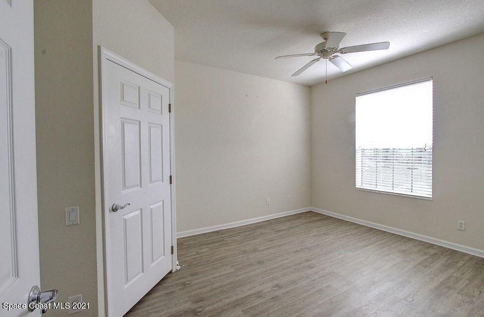 3848 Lexmark Lane, Unit 302 Rockledge, FL 32955 - Photo 11 of 18 a view of an empty room with wooden floor and a window