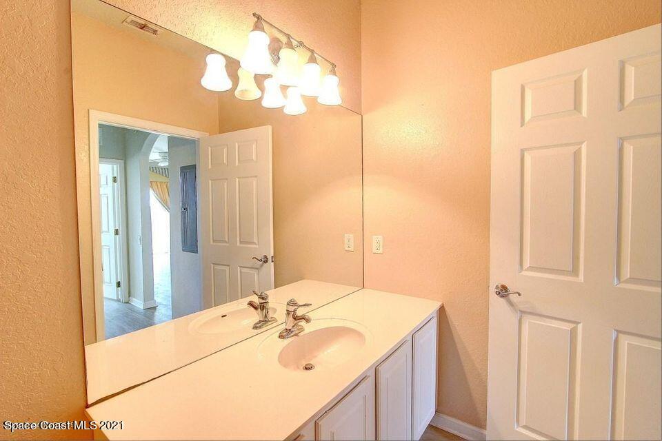 3848 Lexmark Lane, Unit 302 Rockledge, FL 32955 - Photo 15 of 18 a bathroom with a sink and a mirror