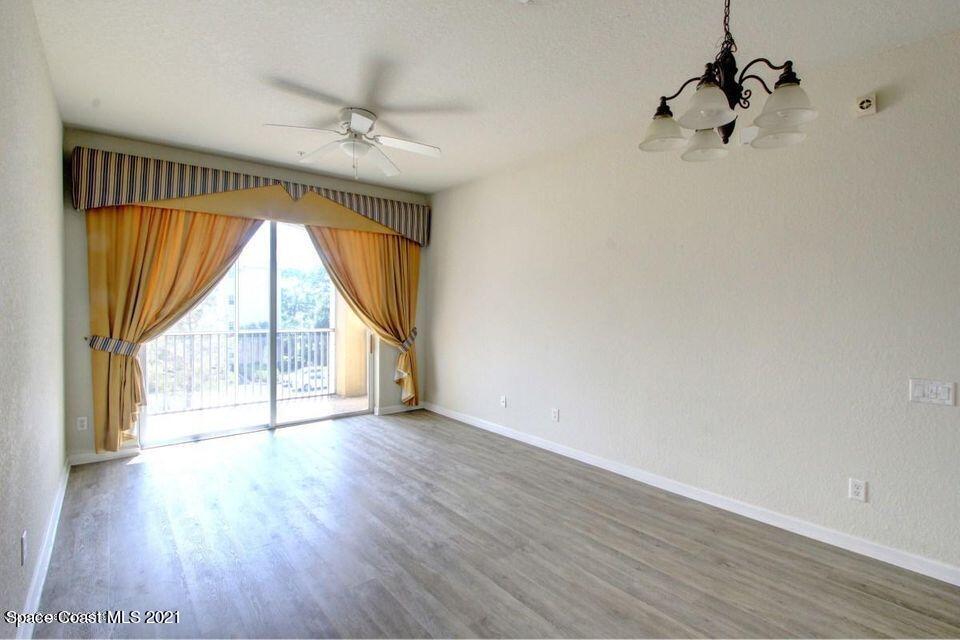 3848 Lexmark Lane, Unit 302 Rockledge, FL 32955 - Photo 4 of 18 wooden floor in an empty room with a window