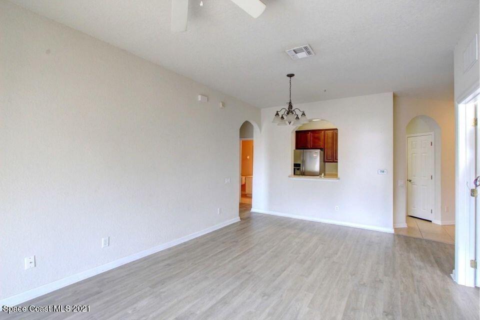 3848 Lexmark Lane, Unit 302 Rockledge, FL 32955 - Photo 6 of 18 a big room with wooden floor and a window