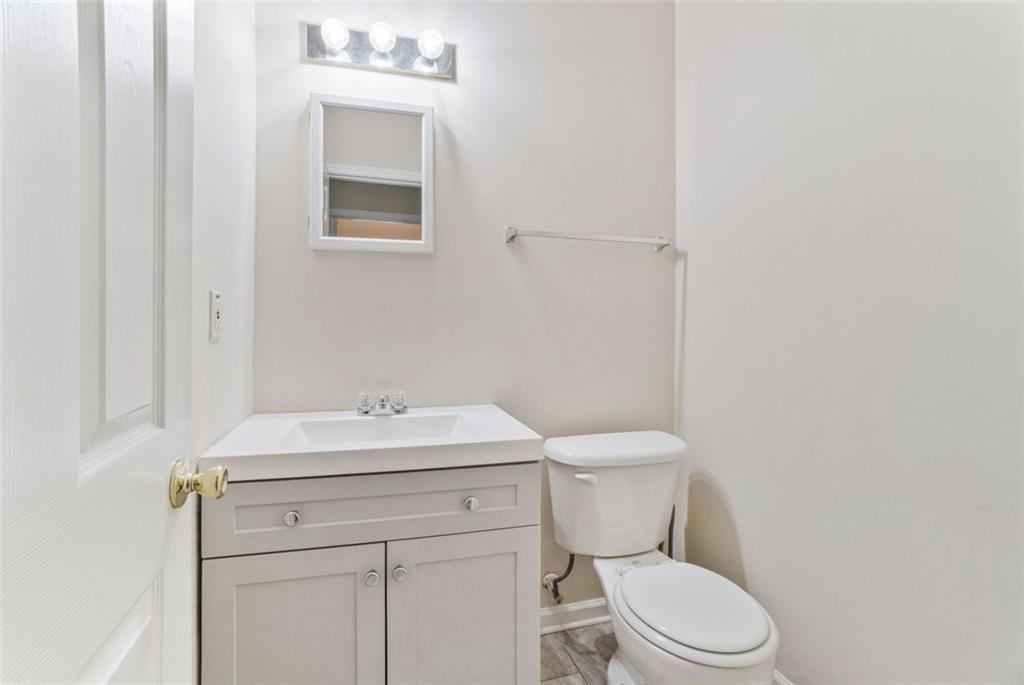 675 Michael Circle Monroe, GA 30655 - Photo 20 of 34 a bathroom with a toilet sink vanity and mirror