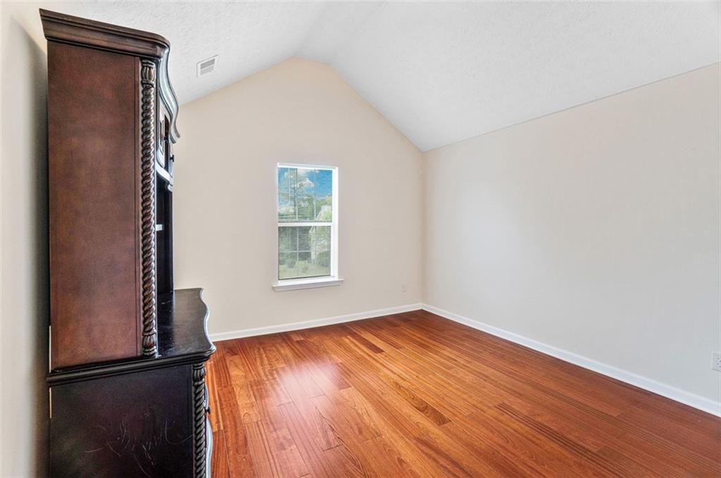 675 Michael Circle Monroe, GA 30655 - Photo 26 of 34 an empty room with wooden floor and windows