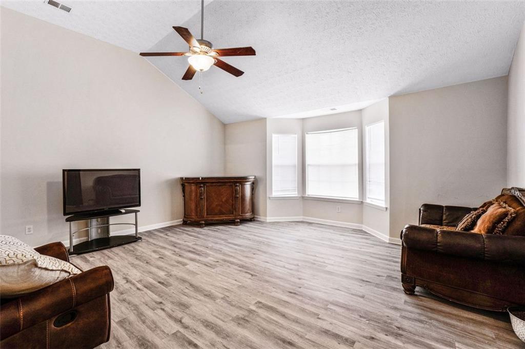 675 Michael Circle Monroe, GA 30655 - Photo 7 of 34 a living room with furniture and a flat screen tv