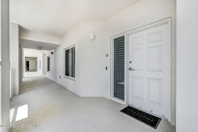 a view of a livingroom with wooden floor and a window