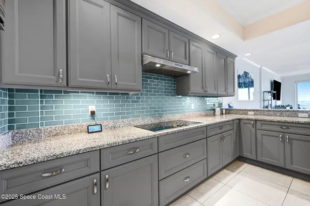 a kitchen with stainless steel appliances granite countertop a sink and dishwasher with white cabinets
