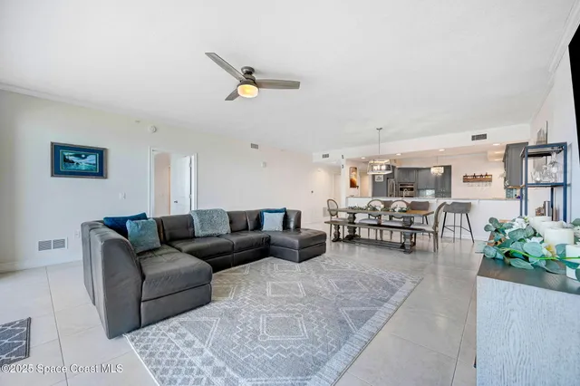a living room with furniture and kitchen view