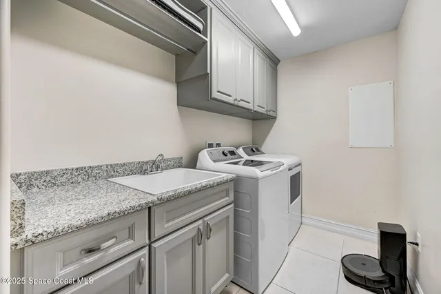 a utility room with sink dryer and washer