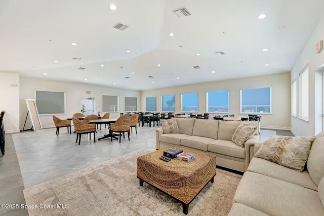 a living room with furniture and view of kitchen
