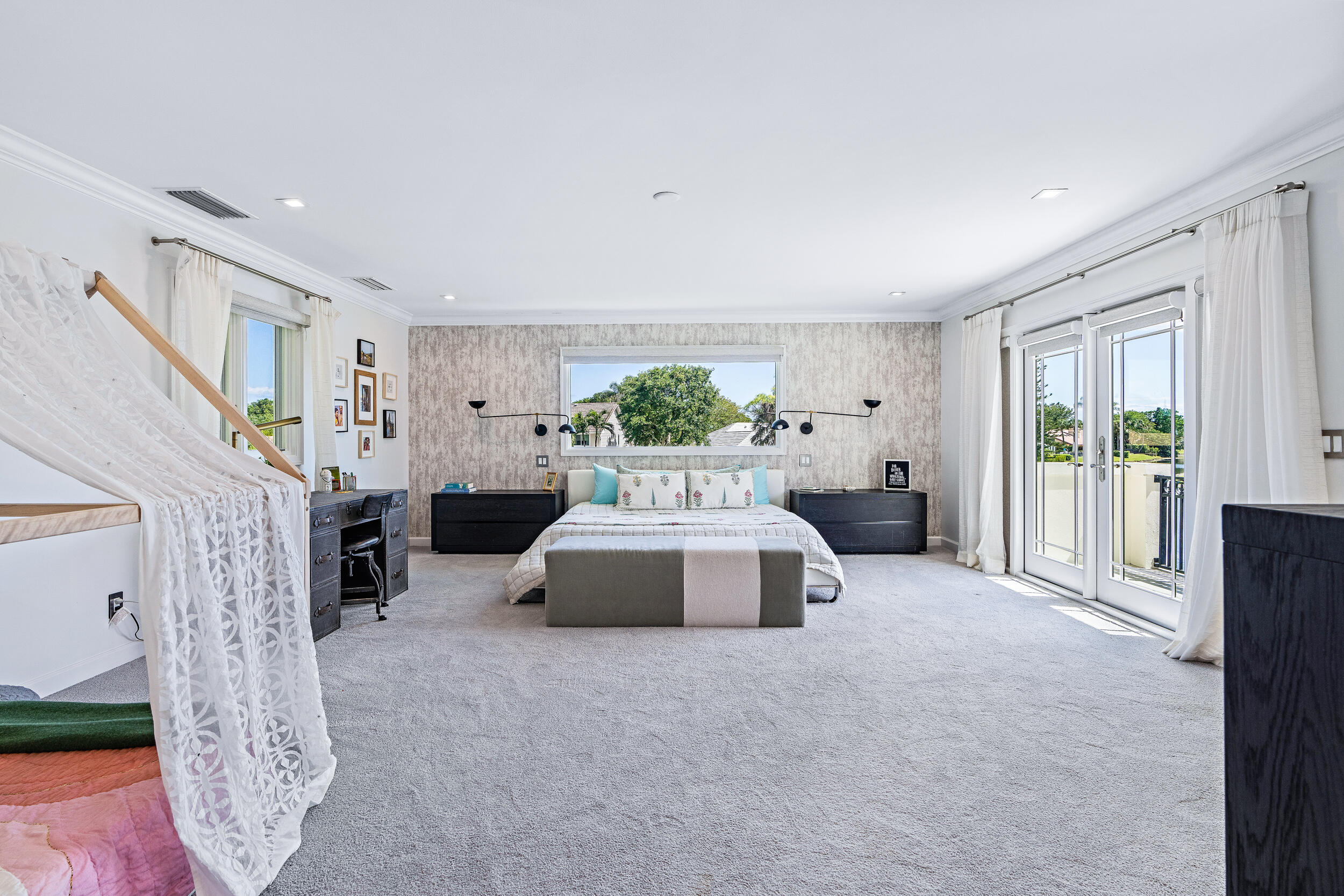 3 Sheldrake Circle Palm Beach Gardens, FL 33418 - Photo 15 of 48 a spacious bedroom with a large bed and a chandelier