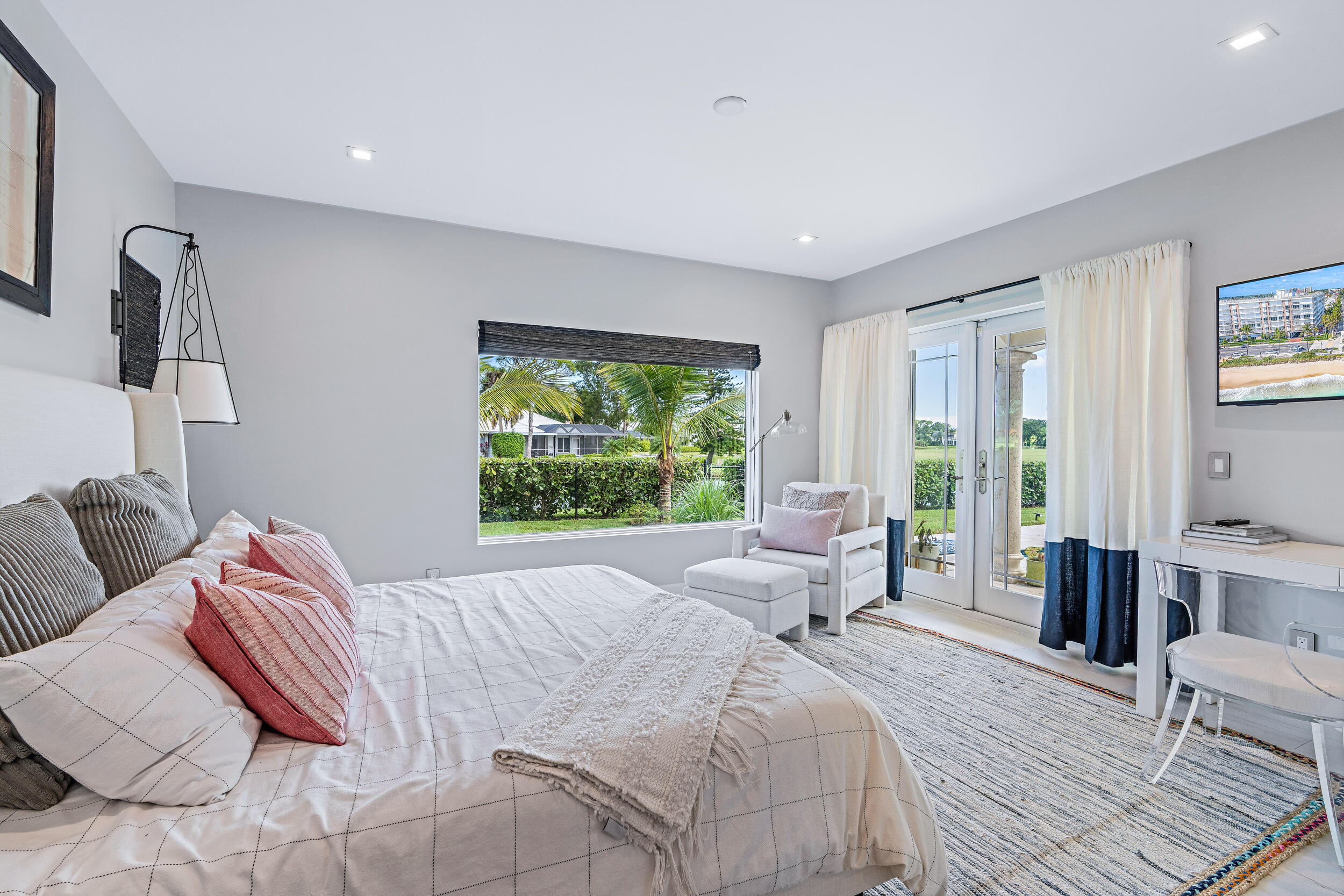 3 Sheldrake Circle Palm Beach Gardens, FL 33418 - Photo 22 of 48 a bedroom with a bed and large windows