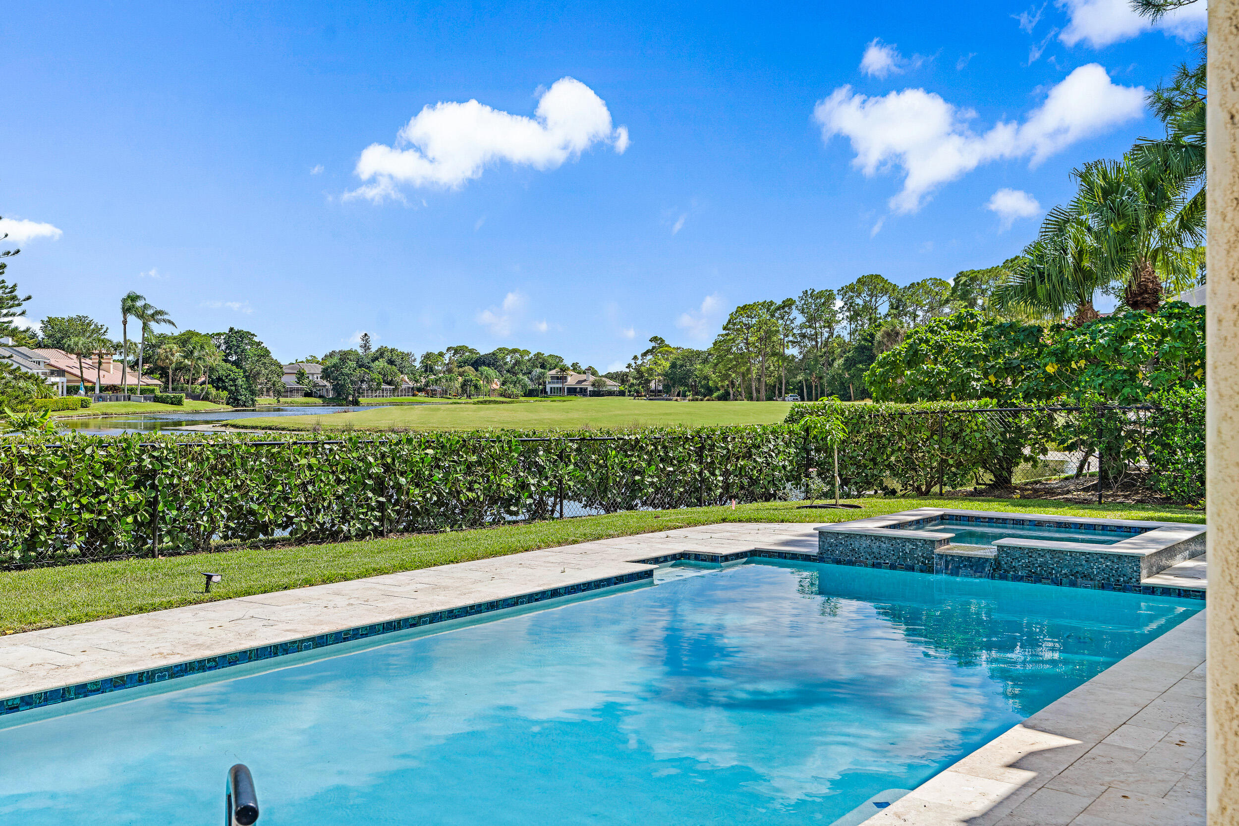 3 Sheldrake Circle Palm Beach Gardens, FL 33418 - Photo 27 of 48 a view of a swimming pool with an outdoor space and seating area