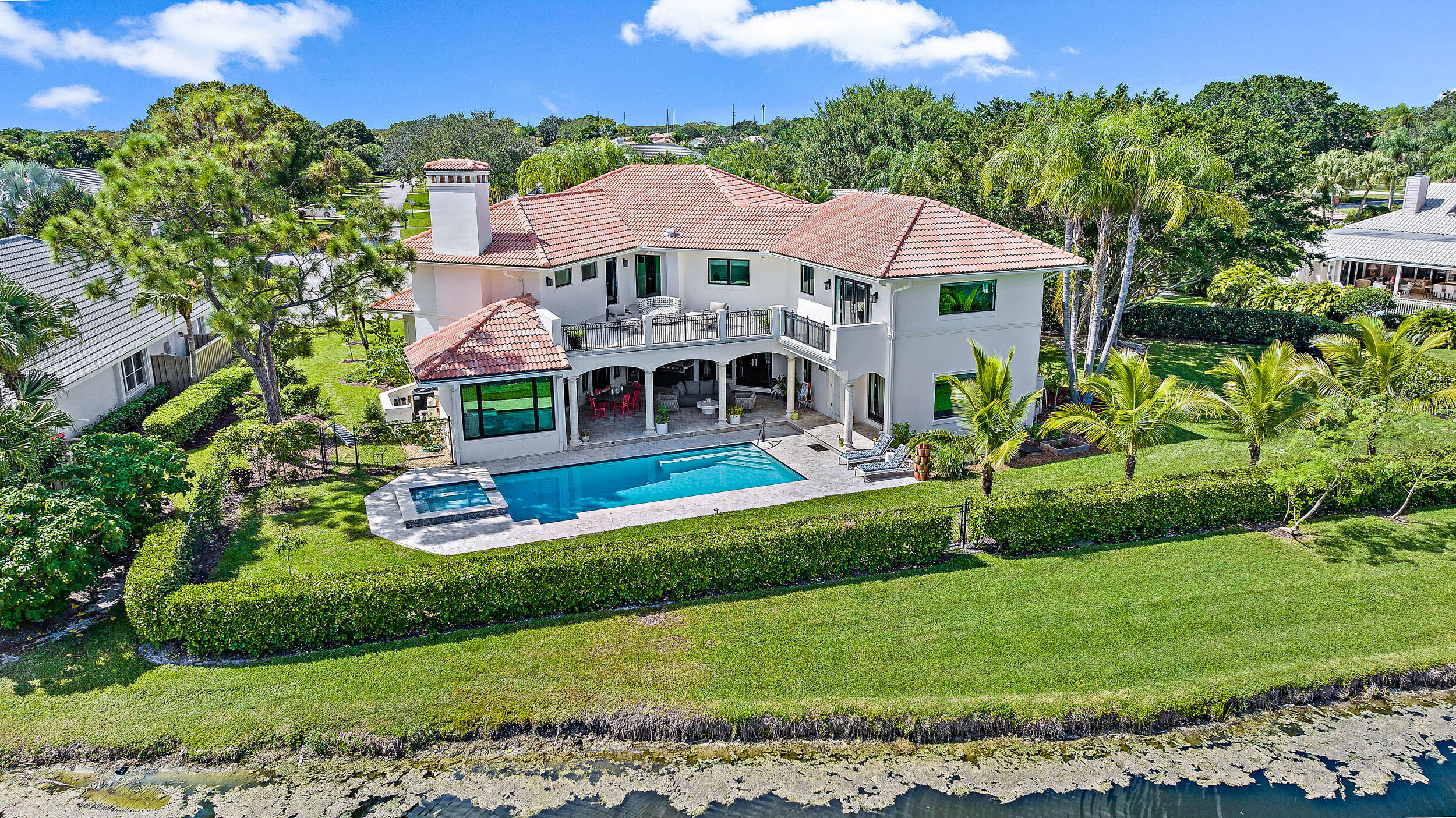 3 Sheldrake Circle Palm Beach Gardens, FL 33418 - Photo 3 of 48 a front view of a house with a garden