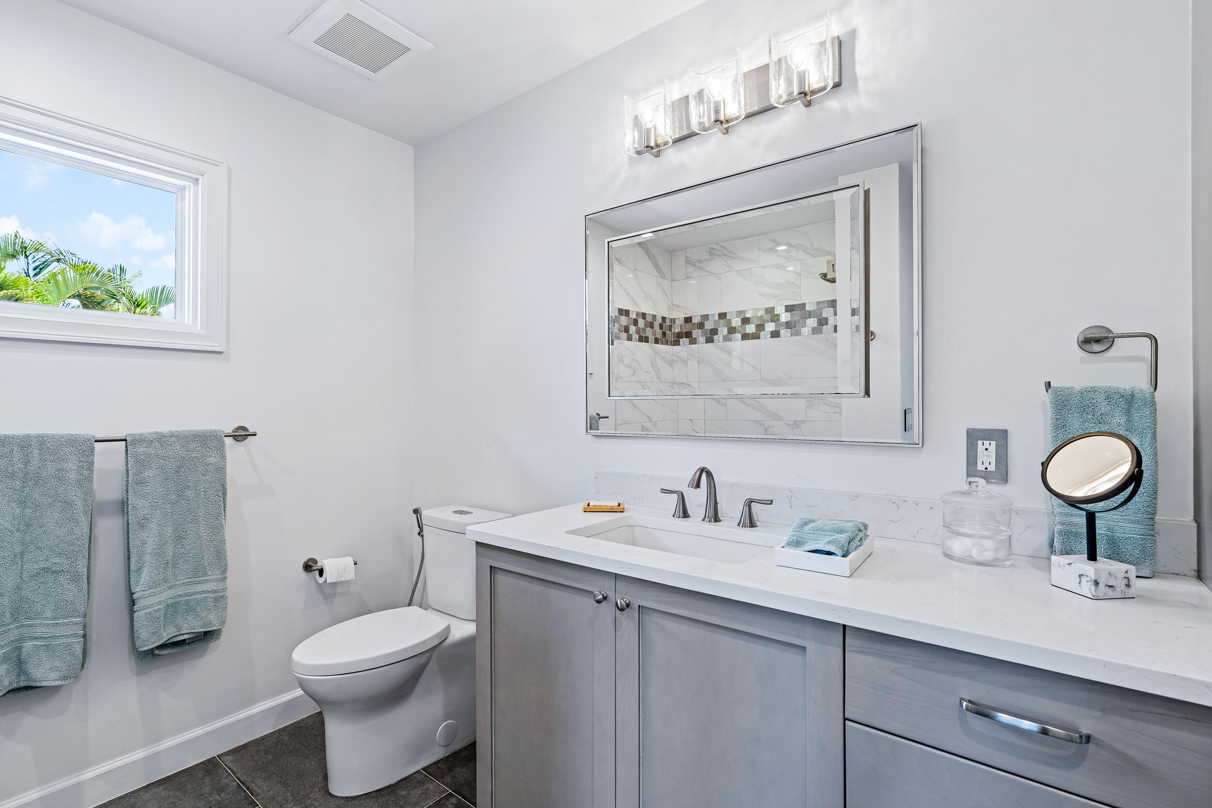 3 Sheldrake Circle Palm Beach Gardens, FL 33418 - Photo 32 of 48 a bathroom with a toilet sink and mirror
