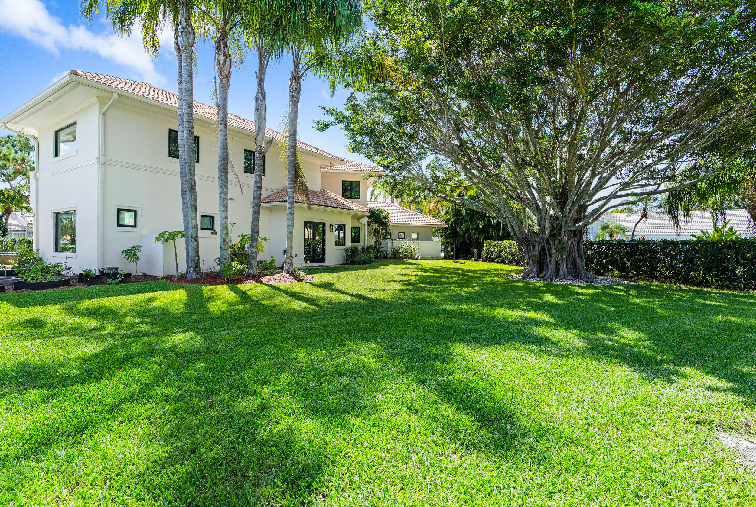 3 Sheldrake Circle Palm Beach Gardens, FL 33418 - Photo 34 of 48 a view of a house with a big yard and large trees