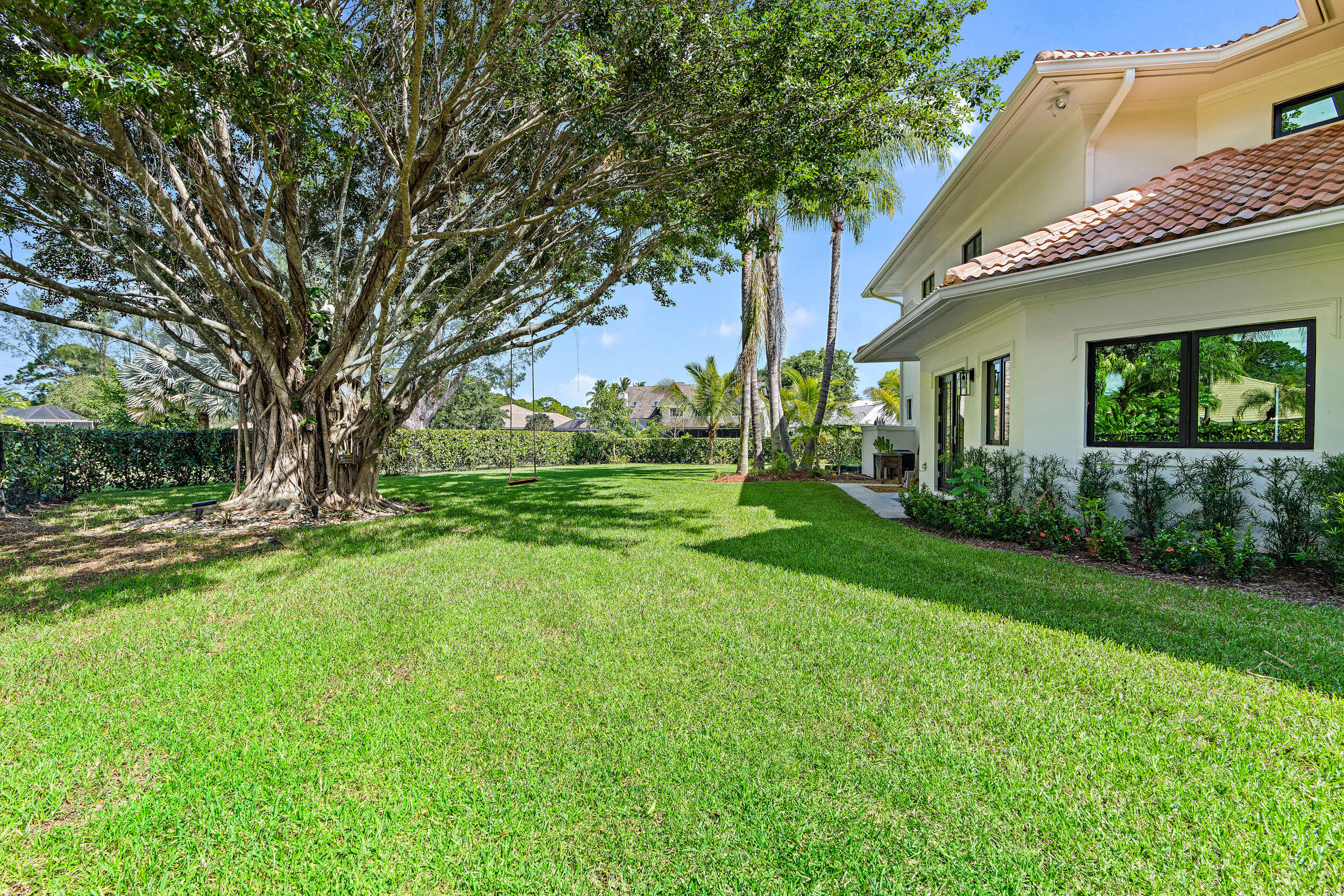 3 Sheldrake Circle Palm Beach Gardens, FL 33418 - Photo 35 of 48 a view of a house next to a big yard and large trees