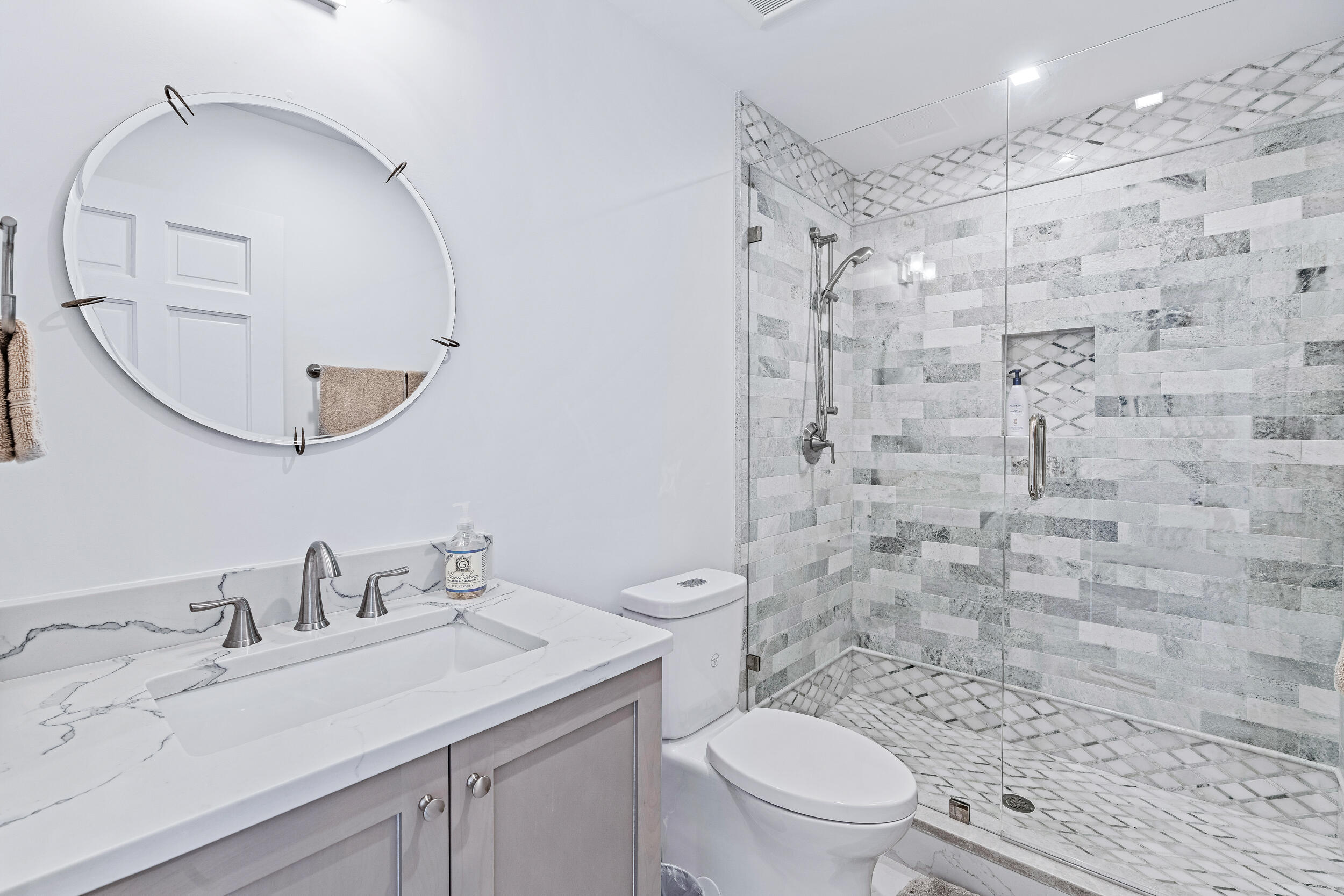 3 Sheldrake Circle Palm Beach Gardens, FL 33418 - Photo 38 of 48 a bathroom with a granite countertop sink a toilet and a mirror
