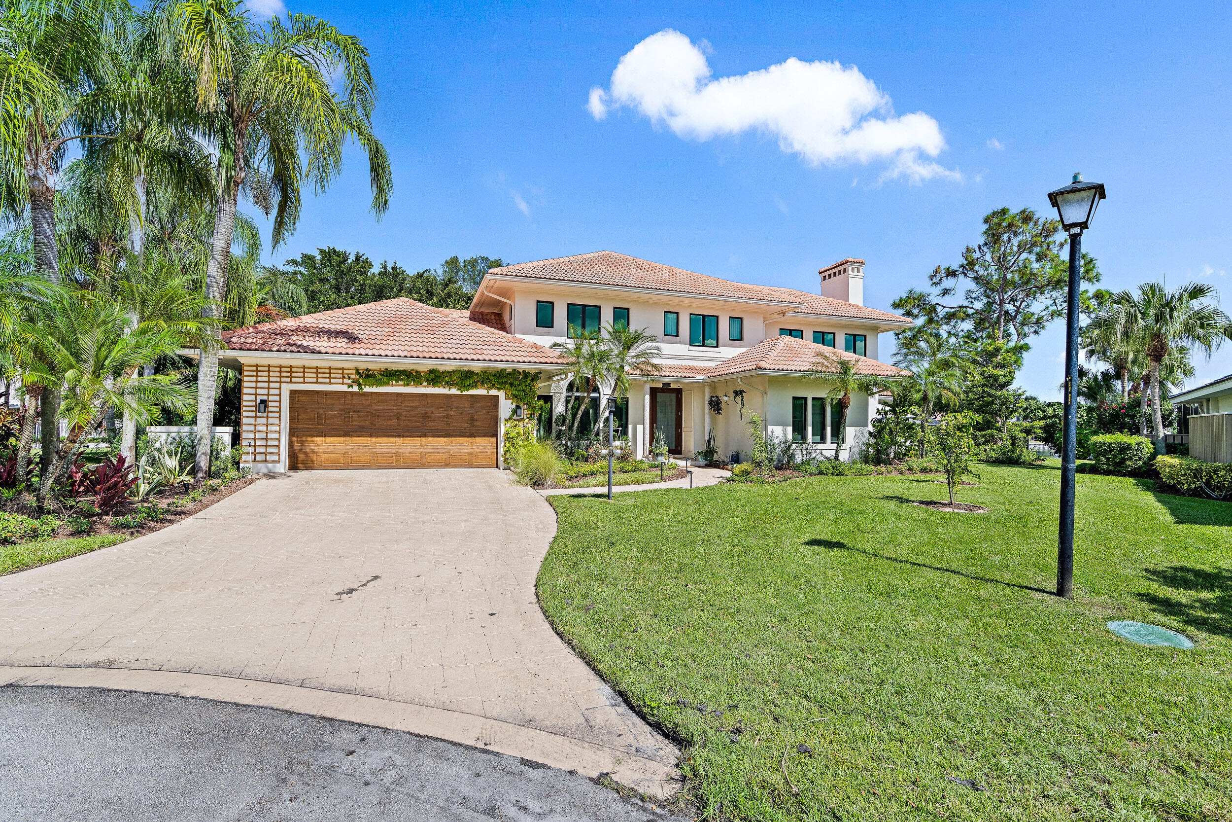 3 Sheldrake Circle Palm Beach Gardens, FL 33418 - Photo 42 of 48 a front view of a house with a yard