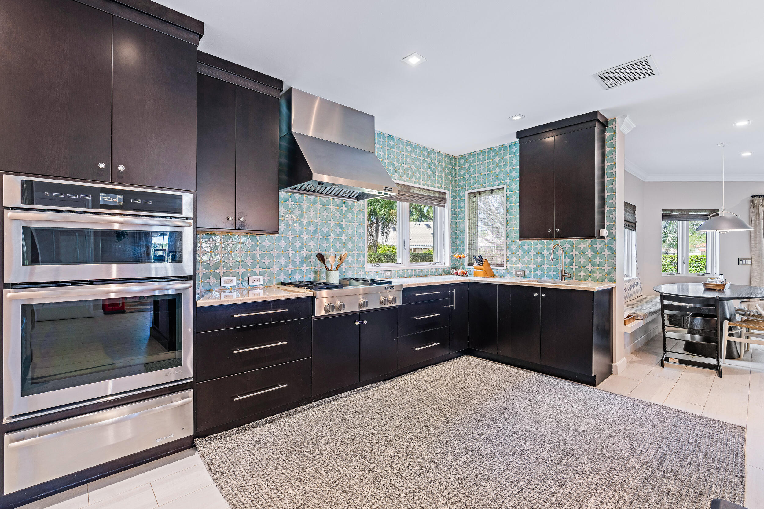 3 Sheldrake Circle Palm Beach Gardens, FL 33418 - Photo 5 of 48 a kitchen with stainless steel appliances kitchen island granite countertop a refrigerator stove and sink
