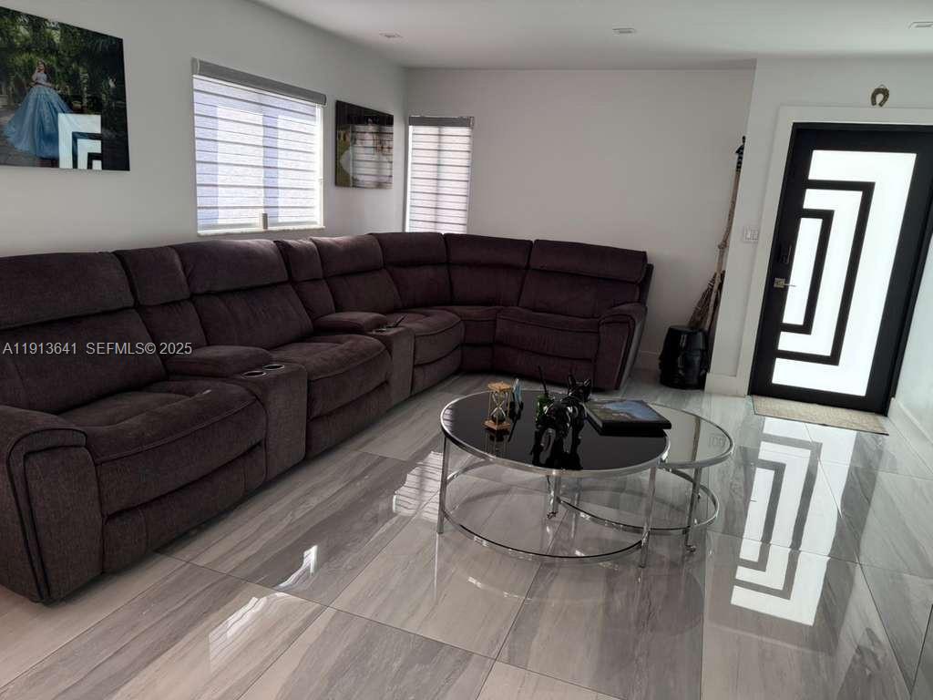 717 Tamiami Canal Road Miami, FL 33144 - Photo 12 of 15 a living room with furniture and a window