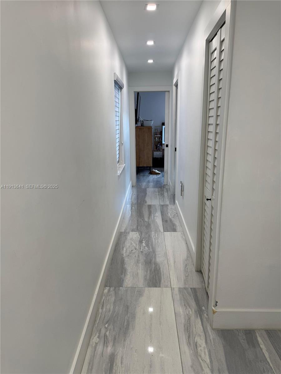 717 Tamiami Canal Road Miami, FL 33144 - Photo 14 of 15 a view of hallway with walk in closet