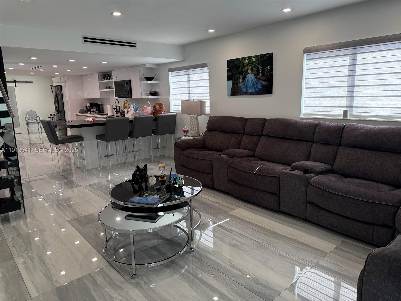 717 Tamiami Canal Road Miami, FL 33144 - Photo 6 of 15 a living room with furniture and a wooden floor