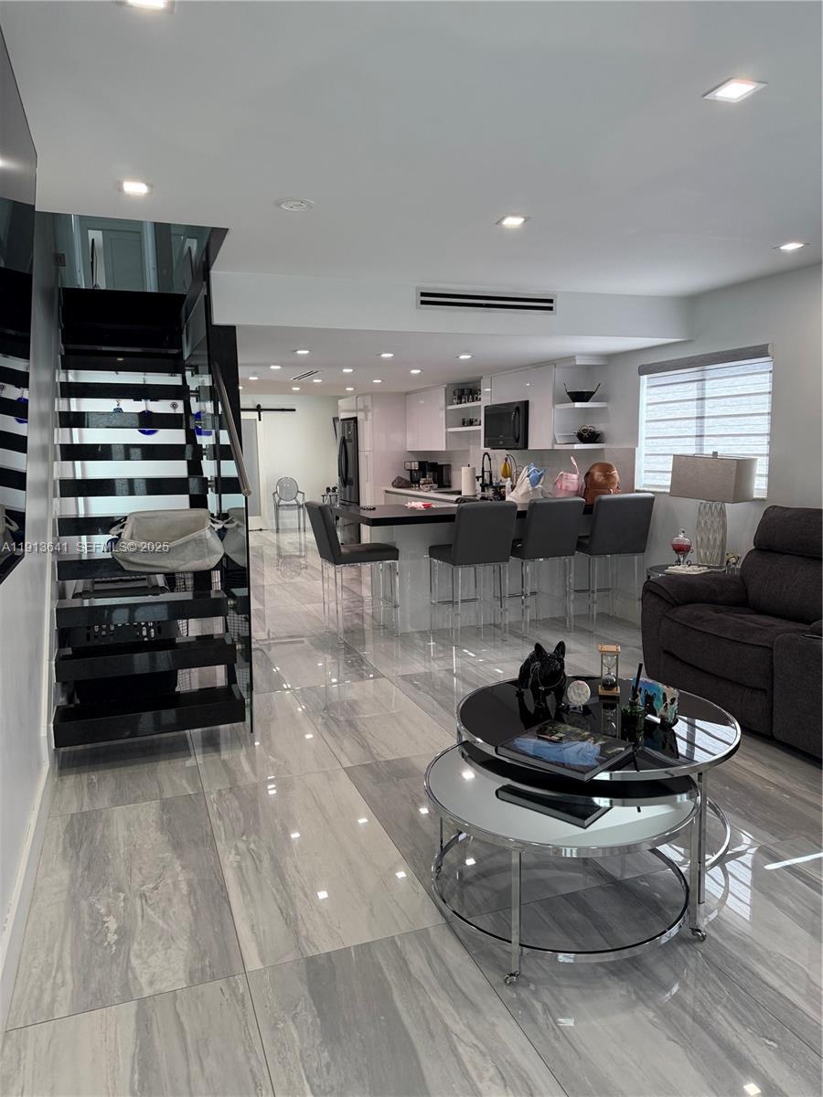 717 Tamiami Canal Road Miami, FL 33144 - Photo 7 of 15 a living room with furniture and a flat screen tv