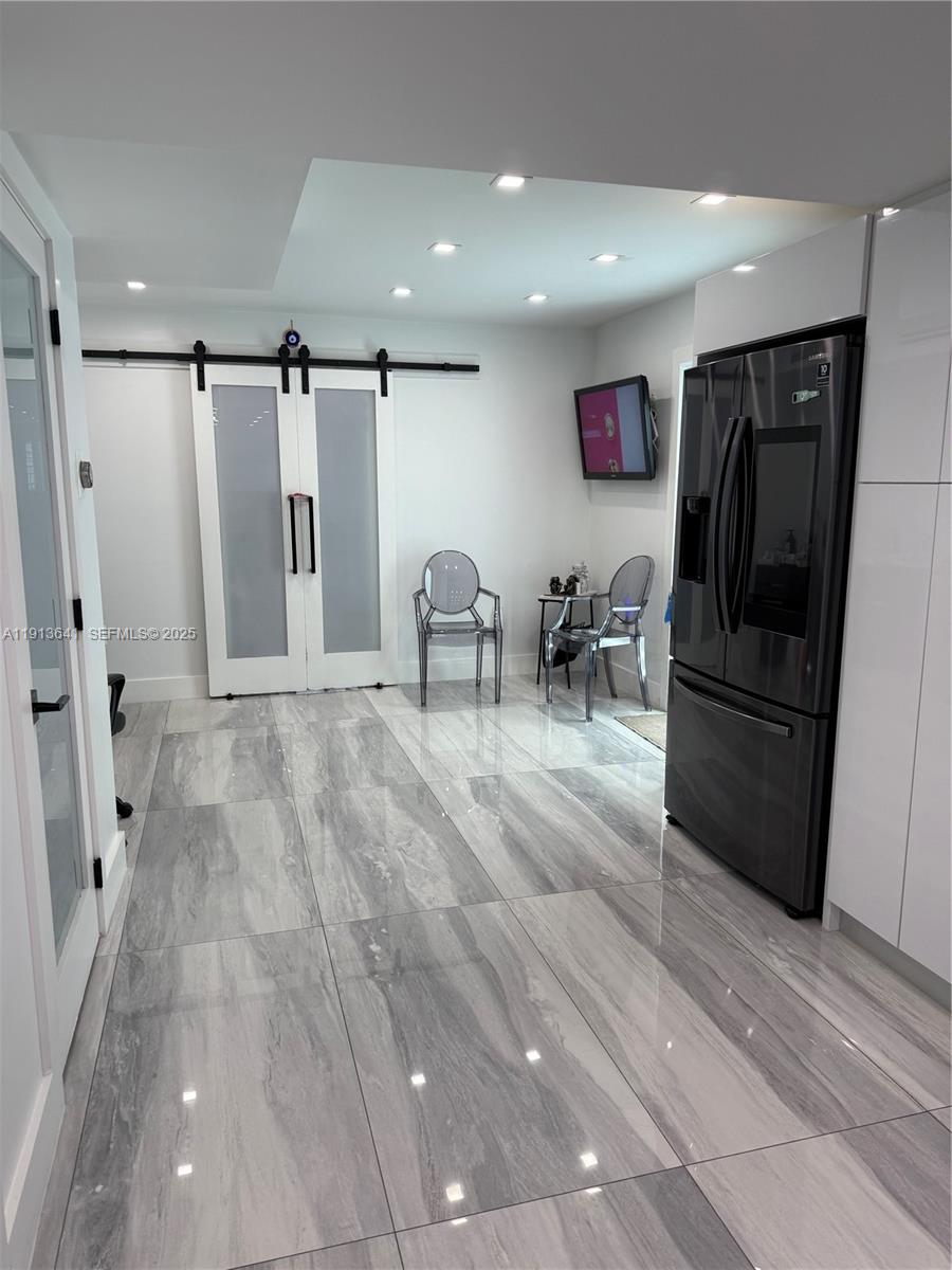 717 Tamiami Canal Road Miami, FL 33144 - Photo 9 of 15 a view of kitchen with furniture and refrigerator