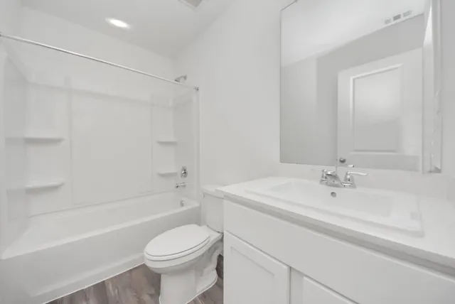 an empty room with a window and ceiling fan