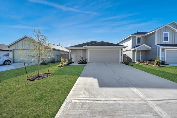 a view of swimming pool with seating space and trees in the background