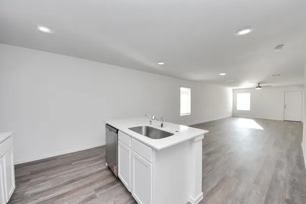 a view of a kitchen with a sink and a refrigerator