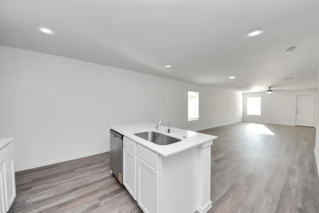a view of a kitchen with a sink and a refrigerator