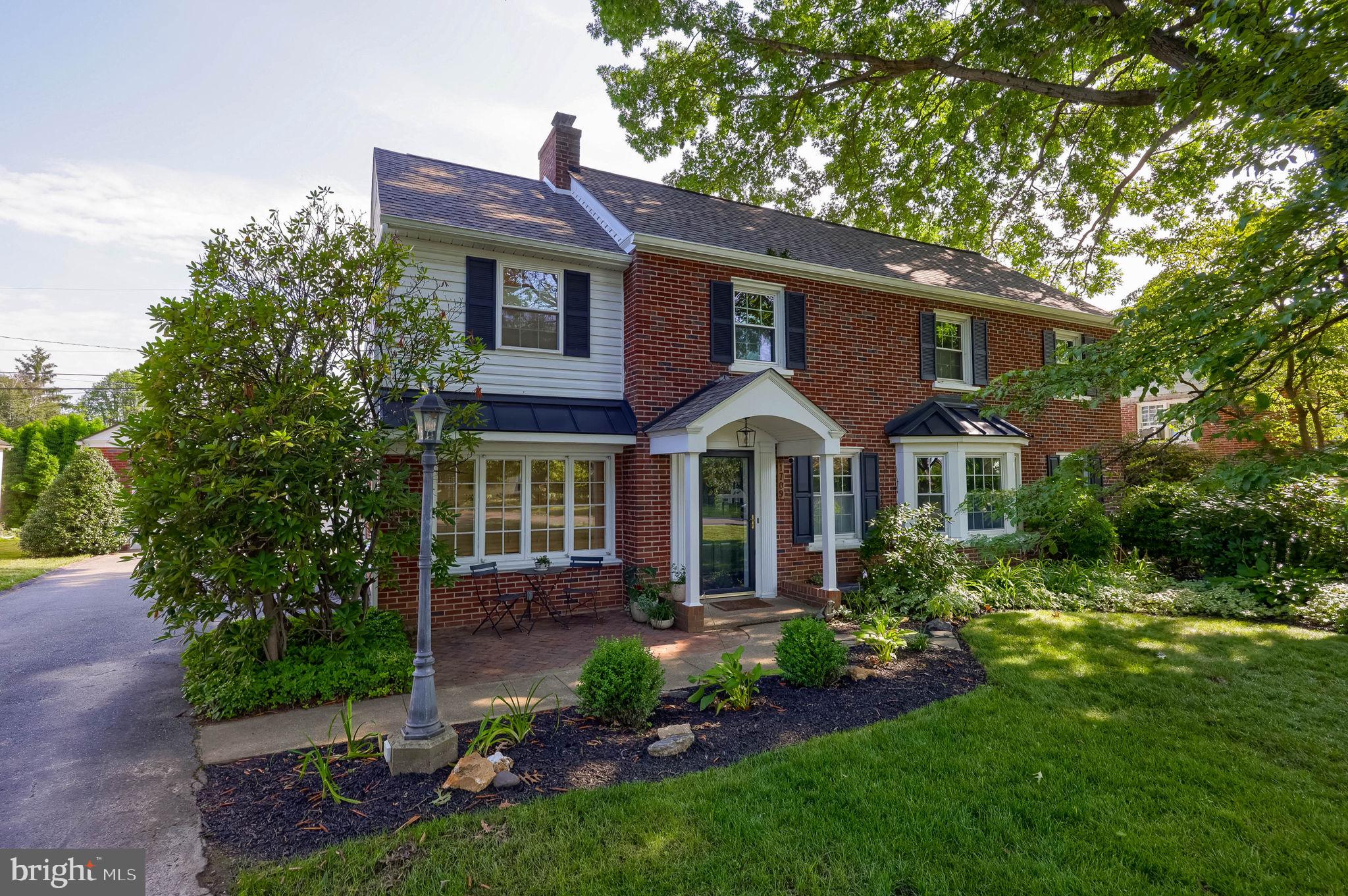 1709 Ridgeview Avenue Lancaster, PA 17603 - Photo 1 of 77 Charming brick home with lush greenery.