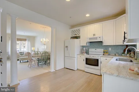 a kitchen with stainless steel appliances a stove a sink a refrigerator and cabinets