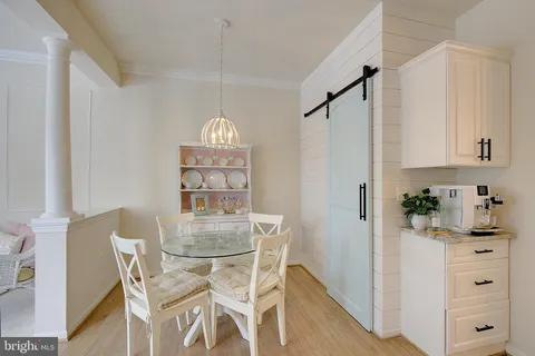a kitchen with a table chairs refrigerator and cabinets