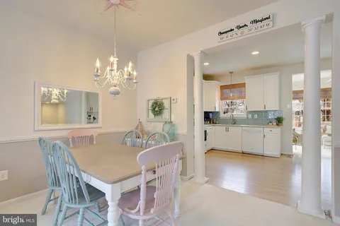 a view of a dining room with furniture and chandelier