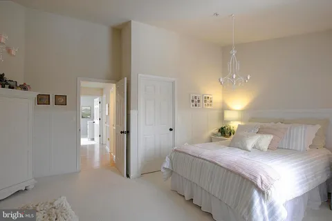 a bedroom with a bed and a lamp