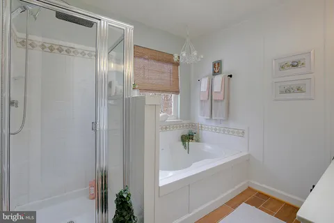 a bathroom with a tub and shower