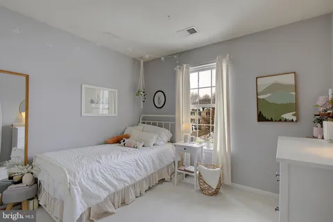 a bedroom with bed and a window