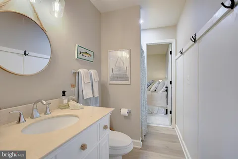 a bedroom with a bed and painting on the wall