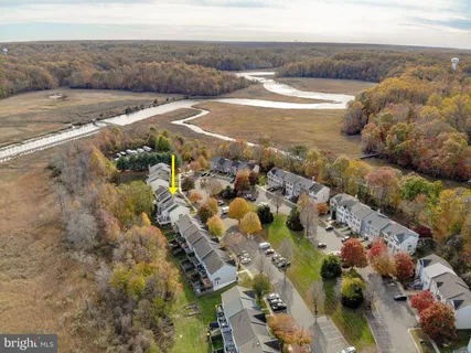 a bird view of multi story residential apartment building with yard