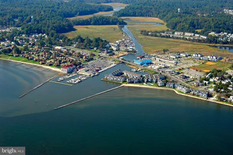 a living room with lots of furniture and a floor to ceiling window