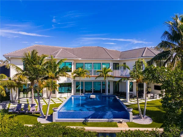 a view of a house with swimming pool and sitting area