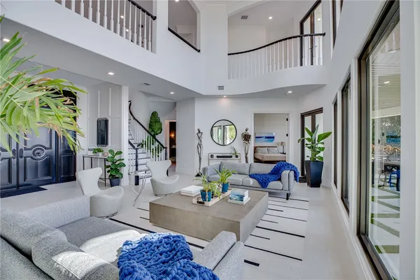 a living room with furniture a chandelier and a rug