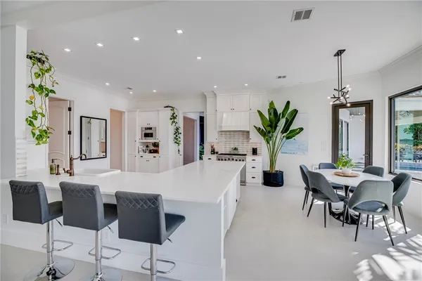 a large kitchen with a table and chairs in it