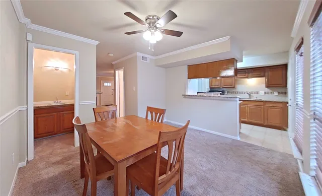 a view of a dining room with furniture and a chandelier