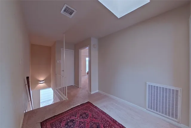 a view of an empty room and wooden floor