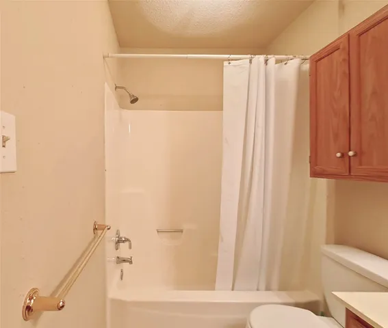 a bathroom with a shower curtain and a shower curtain